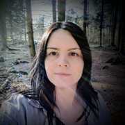 Nikki Pantony with trees behind her in the woods.